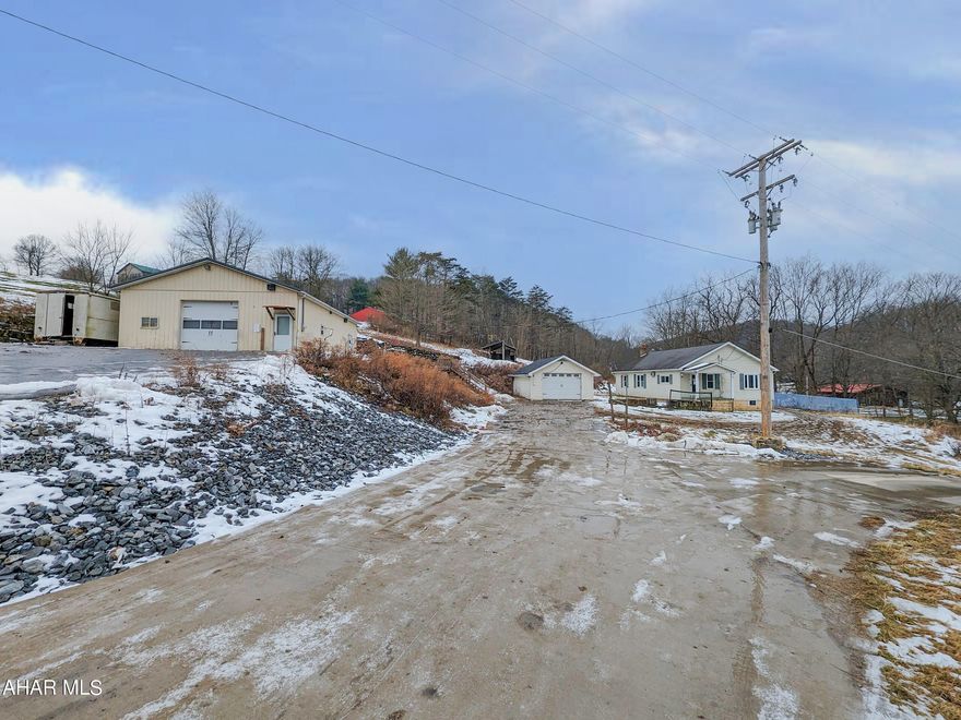 Rare find - 1.8 acres in Hollidaysburg area just outside of Canoe Creek State Park. Includes 1 story 3 bedroom residence, large workshop with overhead door, 1 car detached garage and large pole building w/ overhead doors. Currently zoned manufacturing - farming. Former overhead door company. Change of Use Permit required for other uses. Plenty of space to utilize, enjoy and make it your own. AS-IS sale. Seller will make no repairs.