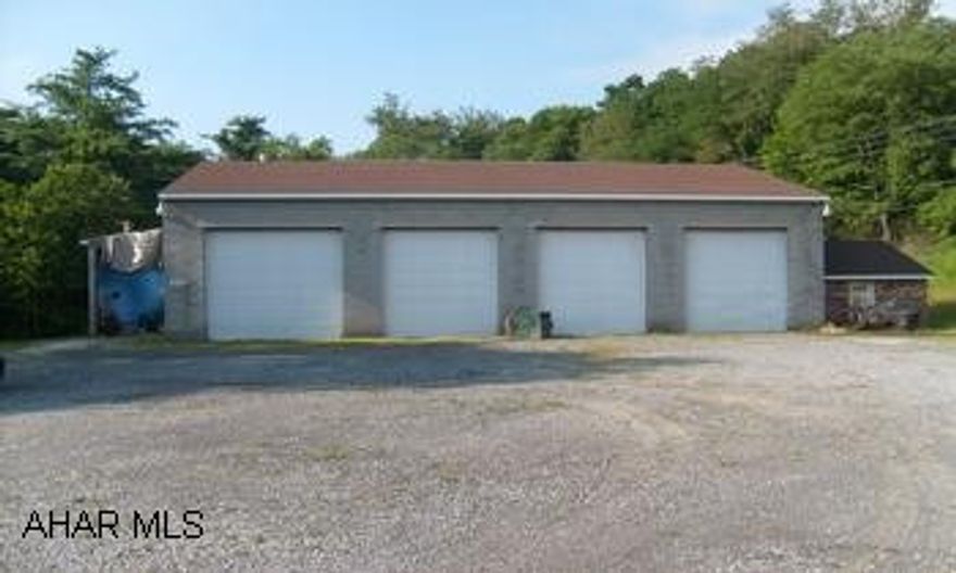Concrete blcok building with four bay doors.
