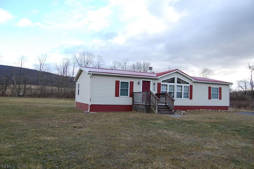 Great opportunity to own a 3 bedroom, 2 bath home situation on over 2 acres of flat land.  Private setting with large play area in the front and back of the house.  Hardwood floors in the family room with a wood burning fireplace.  Master suite with a jacuzzi tub and walk-in closets in every bedroom.  New metal roof in 2019.  Northern Bedford School District.  All appliances included.  Public Sewer with private well.  Call today for a private showing.