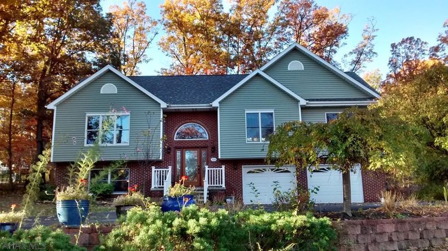 This 3 bedroom, 2 1/2 bath Colonial Revival  bi-level is located in beautiful Beverly Hills Subdivision.  This active neighborhood sits just minutes from both UPMC and Penn State Altoona campus and is a great place to enjoy nature and watch as the sun rises over the mountain.  The owners have done extensive updating and renovating during their period of ownership.  Private patio and backyard call you back to nature.   All new flooring throughout.  The huge upgraded kitchen is a perfect fit for fantastic food prep and conversation.  The vaulted ceilings soar in the main floor and make the gas Mendota fireplace the center of attention.  The grounds are meticulously landscaped..  Roof has 50 year warranty.  New garage doors and siding. 2-bay heated garage.  Home Warranty included.