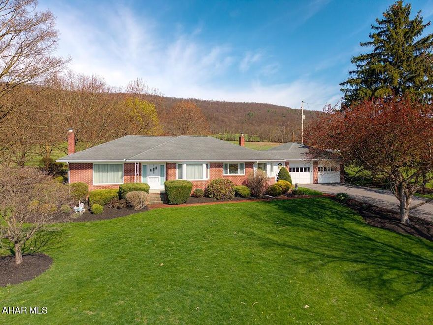 Looking for a beautiful setting in the countryside yet not far from retail stores, restaurants, entertainment? Take a look at this uniquely designed brick rancher on close two acres of land. So many amenities. Plus, the possibility of conversion to an in-law suite in the lower level.  Garage space? You bet! - Attached two car garage with TWO additional garages. One of which could easily store your larger motor home or camper with no problem.  Total of six garage bays. Three-bedroom, 2.5 bath. Comfortable one-story living in a scenic rural setting. Cozy woodburning stove in the lower level to enjoy along with a den/library area.  Lovely rear deck and pergola area. Beautifully landscaped. This one beckons to become your ''Home Sweet Home'' - Call today for your personal tour.