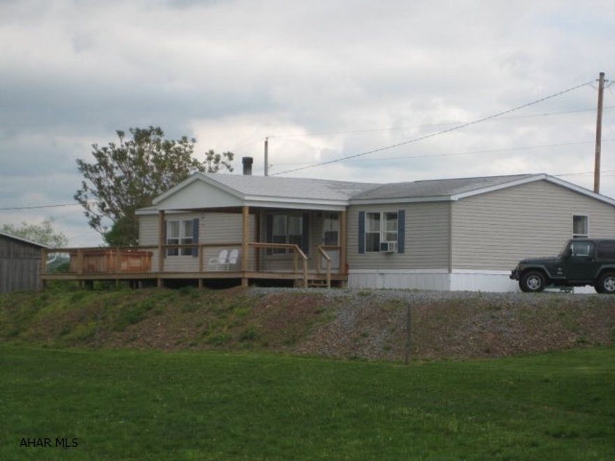 Quiet country living is yours in this updated 28X65 doublewide home situated on 58+ acres. Beautiful Hickory wood floors, updated Master Bath, Stone fireplace in Living Room. Large Bank Barn and Horse Barn with gated riding ring. Both Barn and Horse Barn have water and electricity. Large 12X65 deck overlooks beautiful mountains and vistas. Lounge away in the hot tub while watching the grazing horses and looking at the views. Great hay fields and frontage along Brush Creek make this a great property.