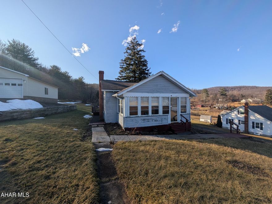 Duncansville 1 story home features large, level lot, 3 bedrooms, 1 bath, large living room, eat-in kitchen and enclosed front porch (3rd bedroom is located near enclosed porch). Large rear deck, storage shed and more! Home has no central heating system - operates on 2 space heaters. On-lot sewage system present; type and operational status are unknown. AS-IS sale, seller will make no repairs.