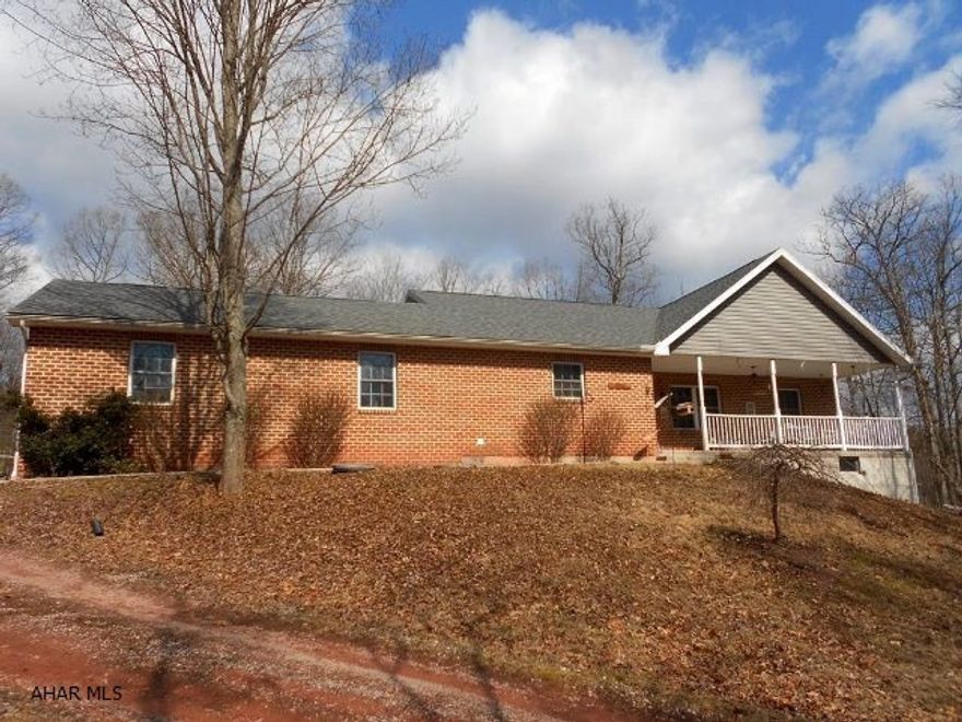 Privacy and wooded surroundings come with this custom built 2004 brick/vinyl ranch home. Three bedroom, 2 full bath, central and open floor plan. Attached two car garage. Supplement heat in basement with a coal/wood stove. Eight foot ceilings in the basement with walk out access. Main level laundry. Enjoy quiet evenings on the covered front porch on your porch swing. Very private.