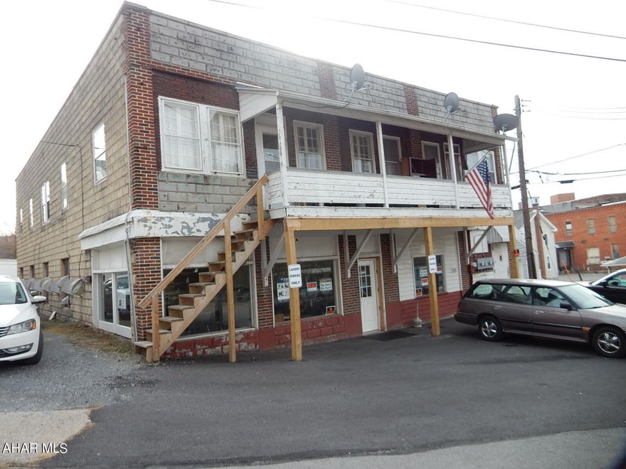 For Sale, A large 2 story multi-use building! 4 2-bedroom Apartments Units on 2nd Floor with Laundromat located on the main floor in Roaring Springs!