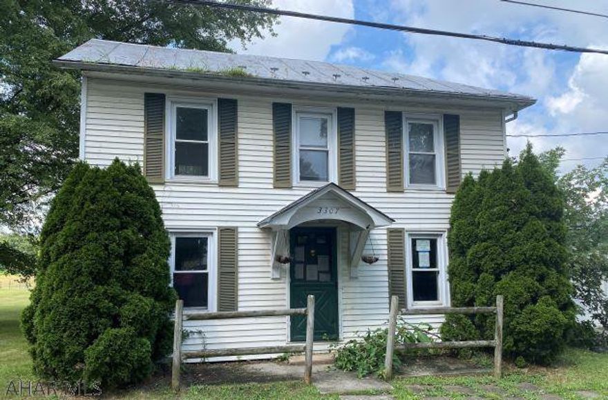 Two story home with 3 bedrooms, one full bath, paved drive with attached one car garage. Home is in need of TLC but has eating area in kitchen with a pantry. Laundry area/mud room has its own access to outside.  Second level enclosed porch supplies attic access. Large open lot and nice yard with two out buildings. Being sold "AS-IS".