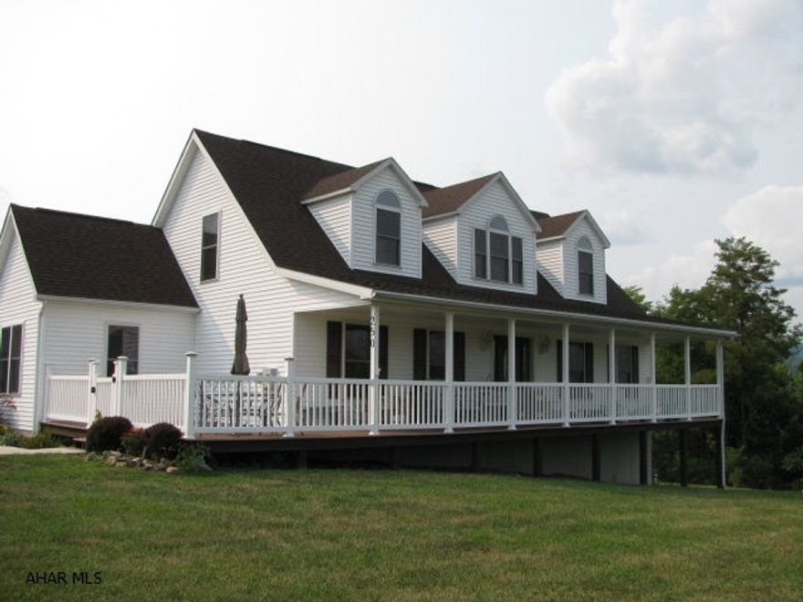 Charming Bellwood cape on 1.6 acres with spectacular views! This home offers spacious LR., DR., EIK., laundry 1/2 bath, master suite w/walk in closet and master bath all on 1st floor! 2nd floor includes 2 more large bedrooms, hall bath and loft area! 2 car oversized detached garage and full basement for storage. wrap around porch and large deck to enjoy the stunning views this home offers! Home Warranty included!