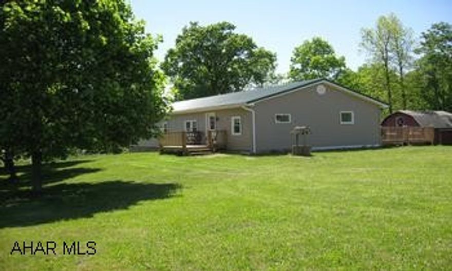 ranch style home with a 2 stall barn, a 20 x 20 barn and a large building was used as a cabinet shop on 4 acres remodeled home with new windows, new metal roof,new siding, new kitchen, new bath, new flooring.