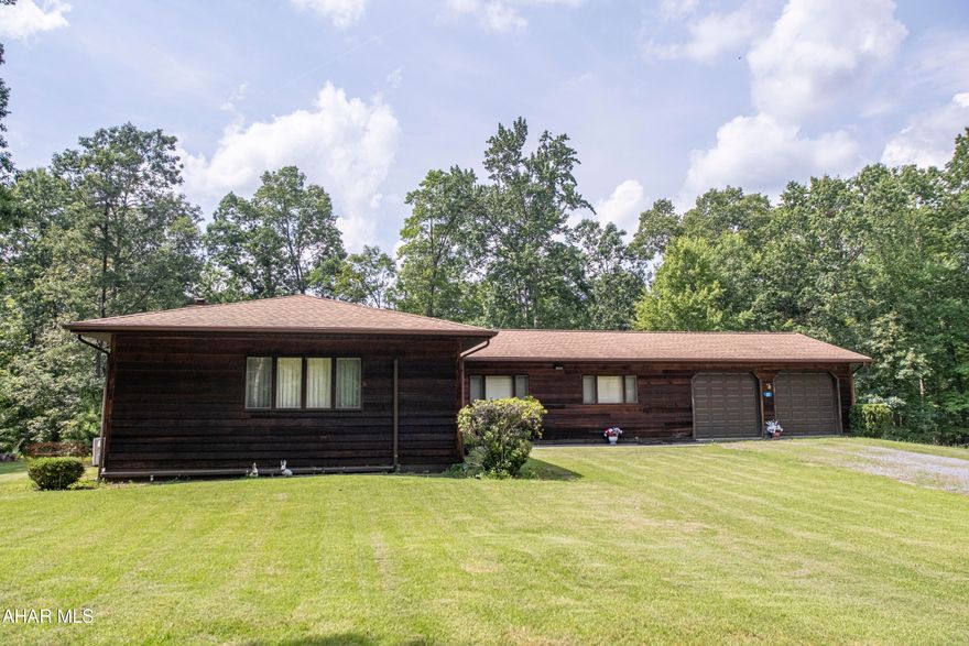 This property offers both space and versatility, ideal for families or investors looking for opportunities. The main floor features a spacious master bedroom with an en-suite bathroom and-a-half bath. The attached two-car garage ensures easy access and ample storage, while the additional detached garage can serve as a workshop or extra storage for recreational vehicles. The walkout basement with covered patio is true highlight, featuring an additional full kitchen and full bath that opens up to endless possibilities for entertaining or creating a separate living space. Two rooms in the basement can become bedrooms with added egress windows, the potential for rental income is appealing, making this property an excellent investment opportunity. Set on over 15 acres, the property offers privacy, backing directly into state land. This unique location offers outdoor enthusiasts an abundance of recreational options from gardening, hiking, hunting or wildlife observation from the comfort of the large deck.