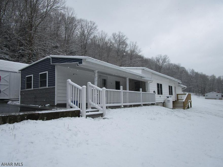 Updated single wide mobile home on over 3 acres.  Well maintained home featuring 3 bedrooms, 1.5 baths, large living room with vaulted ceiling, porch/deck, paved drive and one car garage.