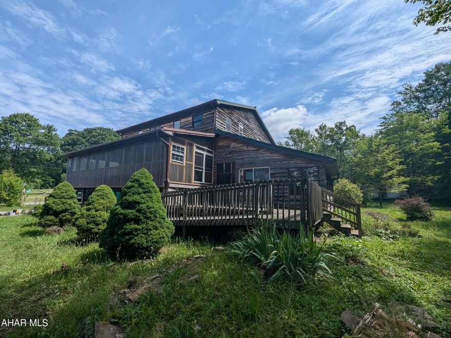 Huge 2 story home on 1.78 acres with large detached 2 car garage/pole building with lots of extra room for workshop, vehicle storage and more. Exterior siding is rough cut lumber with metal roof. Interior features exposed beams, knotty pine trim and ceilings with vaulted ceilings for a unique, rustic feel. First floor features oak kitchen w/ center island, living room, dining room, den plus 3 bedrooms & 2 baths. Second floor loft area with master suite, full bath and walk-in closet. 2 large enclosed porches and rear deck. Property failed pressure test on plumbing. Type and functionality of on-lot sewage system is unknown. May qualify for seller financing (Vendee). Buyer pays both transfer taxes.