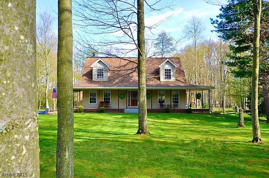 Absolutely stunning cape-cod located in a quiet country setting! This meticulously maintained home has a massive amount of natural light shining into the open floor plan. The living room contains a vaulted ceiling and propane fireplace. Kitchen highlights include the sizable island, double oven and large walk-in pantry. The spacious loft provides additional flexibility. This home offers outdoor living at its finest. It's the perfect setting for entertaining with the patio, fire pit, wide-open yard and built-in horseshoe pits. The best part will be unwinding in the evening on the property's distinctive feature....the impressive wrap-around porch!