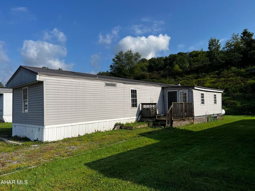 This single wide mobile home on leased land features over 1,200 square feet of living space. Includes washer, dryer, microwave, and stove/oven. Featuring a new metal roof, some new carpeting and fresh paint, this mobile home is move in ready! Buyers must submit a lot lease application with Logan Ridge Mobile Home Community. Schedule your tour today!