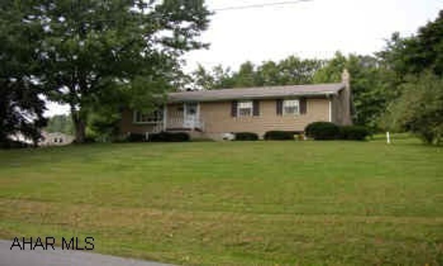 WELL MAINTAINED WITH SPACIOUS ROOMS SITS ON A LOVELY PIECE OF GROUND.