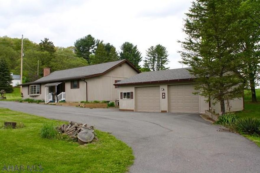 Amazing ranch style 3 bedroom, 2 bathroom home on over 2 acres of land.  Very clean and well-kept home with many great features.  Open concept floor plan that features a large living room and an eat-in kitchen (refrigerator, oven/range, and dishwasher included).  Sunroom off kitchen has a woodburning fireplace.  Detached 2 car garage with plenty of extra work/storage space.  Garage doors were recently replaced.  There is a shed next to the garage that can be used as a workshop or for storage.  All this with great mountain views!