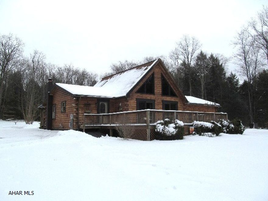 If you want privacy, look no further!  This attractive log home sits on 5 acres and can be used as a year round residence or your very own private retreat.  Close to State Park, boating, fishing, hiking, etc. Loft area is currently used as a guest BR with 1/2 bath. There's an outdoor furnace plus a beautiful stone FP in the LR to keep this home warm and cozy on those cold winter days. Main bath is extra lg w/a garden tub, double sinks and separate shower. Large 2-car attached garage. Two additional BR's and full bath are being completed in the lower level. Priced to sell!