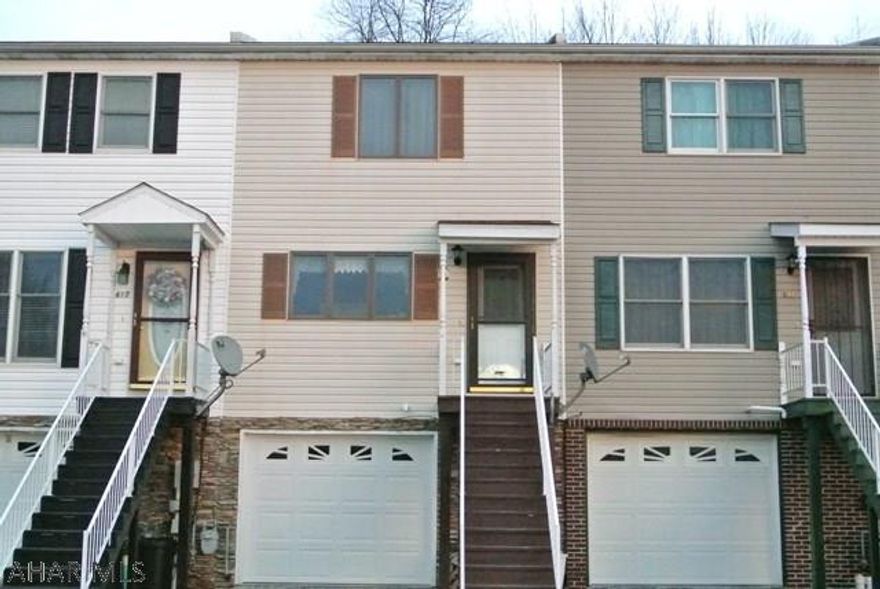 Very darling modern day townhome walking distance to High School.   Perfect home for a small family that wants 'move right in' and simple living.. All the modern amenities including  1st floor half bath, ceramic tile, laminate flooring, large closets, and heated Garage.   You can't find anything this modern and this nice in this price range.   Why buy an old home and spend more money fixing it up when you are ready to go on this one.  This home even offers a flat back yard that borders a wooded property behind it.  Not only do you get an integrated garage to park in, you also have enough off street parking for 4 additional cars.   This has been the first one for sale in quite awhile, I do not expect it to last!!