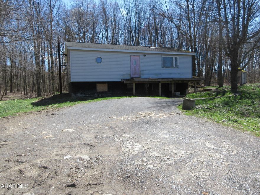 Hastings area double-wide home on 3.6 private acres. Perfect for investors or handy persons. Open concept main living area plus 2 bedrooms and walk-in shower. Needs TLC, but fantastic lot in a private setting. AS-IS sale, seller will make no repairs.  On-lot sewage system present; type and operational status are unknown. Furnace and plumbing system appear to be vandalized, non-functional.