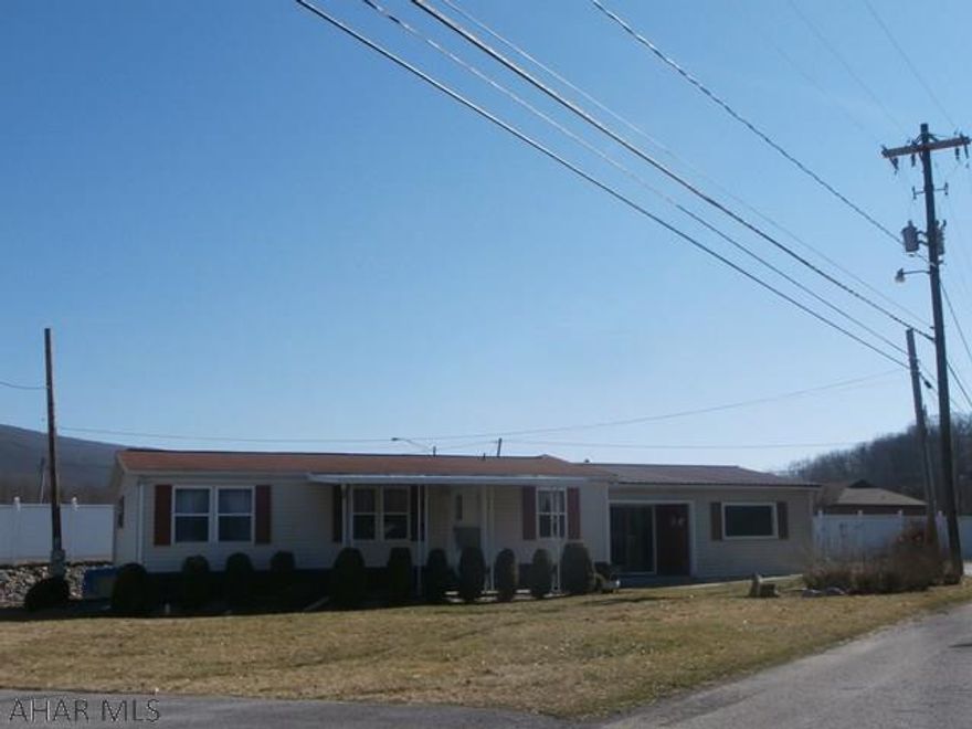 Clean and well maintained doublewide on a mostly level lot. Vinyl sided with a front covered patio and attached 2 car garage.Additional detached two car garage with workshop and office attached. Paved drive. Home has eat in kitchen and living room with cathedral ceilings. Laundry off kitchen. Master bedroom has a bath off with garden tub and shower. Great home for the $$.