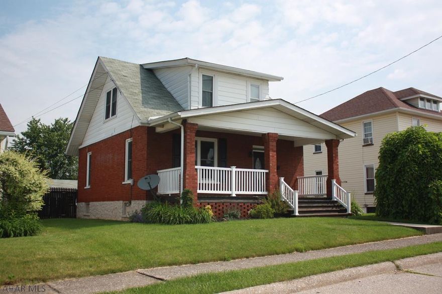 This Solid Brick home is ready for a family.   This property features  3 bedrooms, dinning room, living room, all with dark stained original hardwood floors.  There are Ceiling Fans throughout the home, Cozy front porch for sitting and relaxing or chatting with neighbors.  The backyard is fenced, has an above ground swimming pool with large deck, a separate patio with a fire pit for evening gatherings.   The kitchen with oak cabinets has an eat in area for morning chats over a cup of coffee.  There is a 2 car garage with electronic door openers and workbenches, and lots of parking space beside the garage and the basement has a bar and lots of room  for more opportunities, maybe winter get together's.    Call listing Realtor now for a personal tour of this beautiful home.