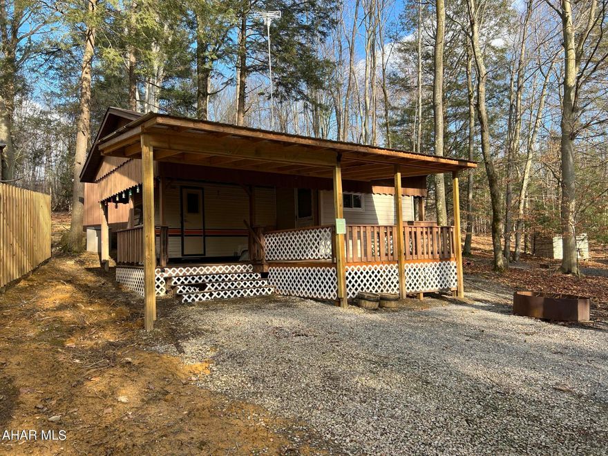 Get a jump on the 2023 camping season with this camper/cabin in Glendale Yearound. An addition to the camper expands the kitchen/living area for more space. Bathroom has a full size walk-in shower. Roof enclosure over the camper with an extra large deck. There's also a nice sized shed in the back, rear yard faces woods. Spring will be here before you know it!