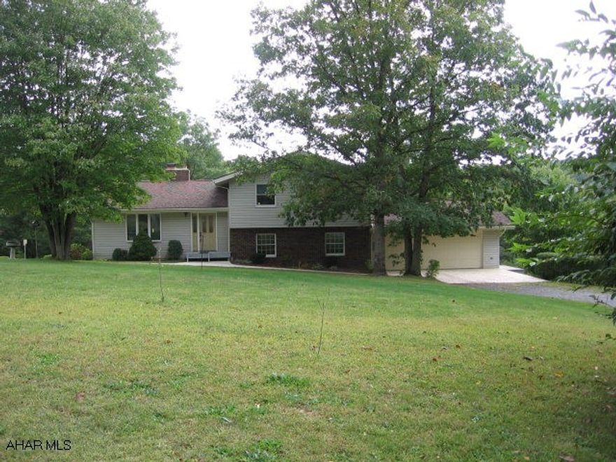Enjoy 10 wooded acres with peaceful setting & wildlife!  Beautiful multi-level home with 4-bedrooms, 2 1/2 baths, stone fireplace, custom made red oak kitchen, formal dining room, family room w/ french doors to patio, hardwood floors, Anderson windows, central air, 2-car attached PLUS 28x28 2-car detached garage w/ 12' ceiling & loft.  J-022