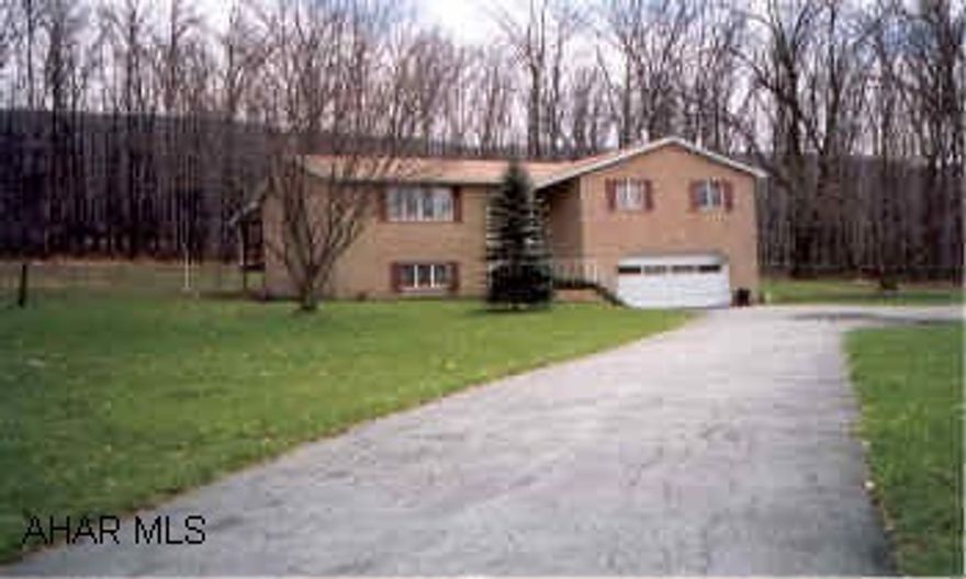 Backs up Highway-surrounded on 3 sides by woods Logan Twp. Solid Brick on 3.9 Acres, Very private, Heavily Wooded 3 sides, Lg Master Bedroom, Large Oak Eat-in Kitchen