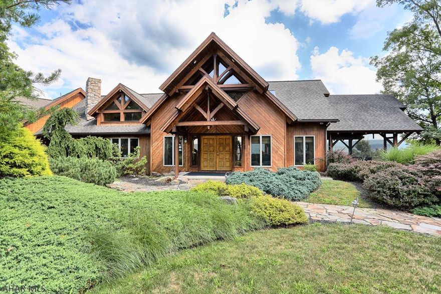 Lots of WOW factor plus fabulous views of Lake Raystown. Creative lake home w/big beams, vaulted ceilings, recessed lighting, hardwood floors in great room & DR. Kitchen & baths are ceramic tile. 3 fireplaces-2 wood, 1 gas-fired. Unique features throughout-tree w/winding stairs that wrap around it from loft to basement, stone shower, water feature, window designs in vaulted ceilings. Gorgeous kitchen w/beams, Viking range, circular eat-in island. Jacuzzi in MBath plus balcony w/outside shower. Loft above great room.  New railing & AZEK flooring on decks. Screened-in porch w/views. Professional landscaping. 24x18 B&B 'hut' has hot tub, kitchen, 3/4 bath, sleep area, deck w/views of lake. 7 garage bays-2 w/large doors for boas. All of this and in close proximity to Shy Beaver boat launch!