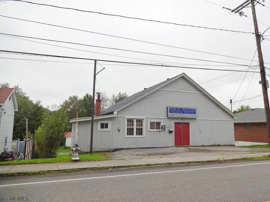 Commercial building used as a construction firm office, storage, & workshop. Basement area offers great storage- main floor spacious & street level. Great access to traffic flow for business on Rt 53
