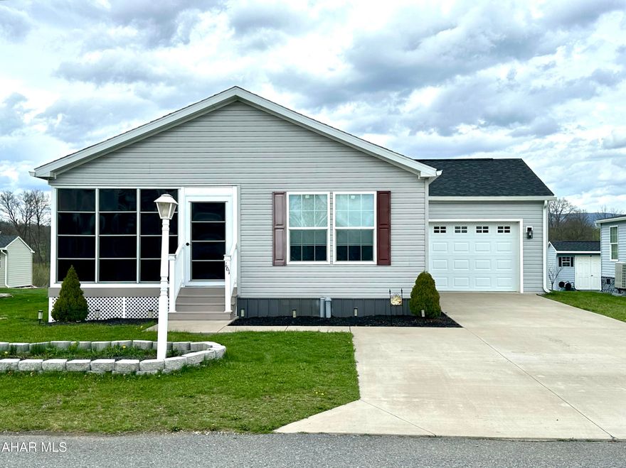 This beautifully maintained 2020 doublewide home offers modern comfort and thoughtful upgrades throughout. A bright and inviting sunroom overlooks the screened-in porch, complete with sliding glass doors--perfect for relaxing or entertaining.

Inside, you'll find elegant finishes including crown molding and custom electronic cloth window blinds with remote operation. The spacious layout features an extra-wide hallway and a large living room accented by built-in cabinetry.

The galley-style kitchen is both stylish and functional, showcasing mocha finished cabinetry, quartz countertops, recessed overhead lighting, a pantry, and an eat-in bar that flows into the dining area. New appliances complete the space.

Bedrooms are generously sized with ample closet space, while the versatile den (or optional bedroom) includes sliding door access to the backyard. The primary suite offers a private retreat with two large closets, dual vanities with an expansive mirror, and a walk-in shower.

Additional highlights include a conveniently located laundry area just off the kitchen, easy access to a 14x24 one-car garage, and a separate shed for extra storage.

This home blends comfort, style, and practicality--ready for you to move right in!

Arrowhead Acres is a 55+ Community. New Owner will apply at the Main for application and requires a background check.