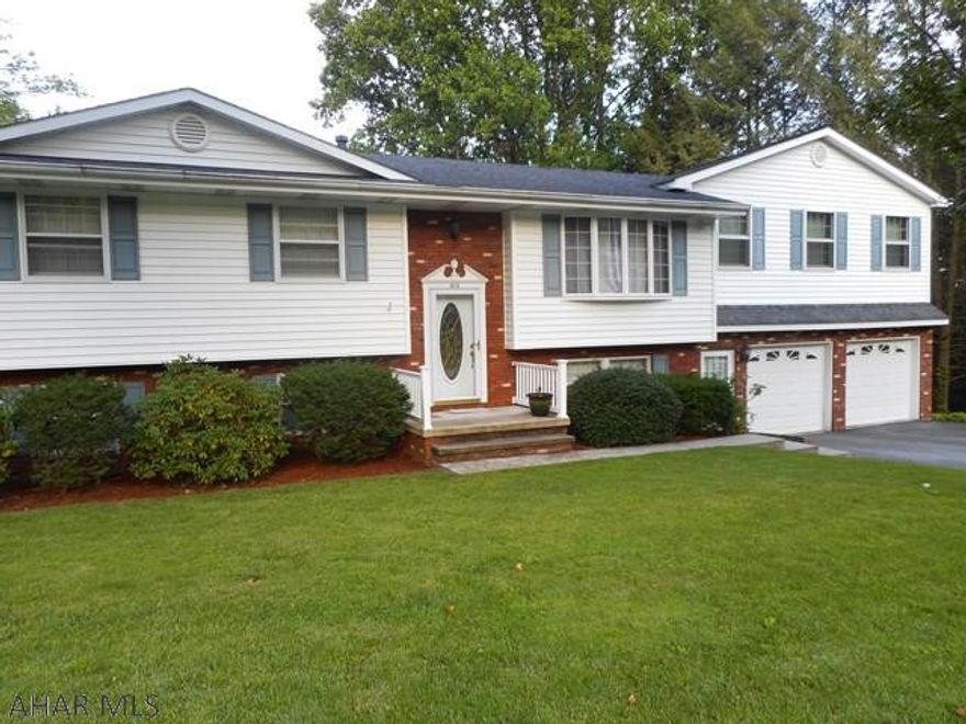 This very special multi-level 4 bedrm, 3 bath home is  on a gorgeous lot. Main level has an updated kitchen with lovely cabinetry, new counter top and ss appliances. Dining rm, with a slider to a deck, has a tremendous view. Living rm, dining rm and kitchen have new pergo flooring. 3 bedrms and full bath complete this level. Upper level has a convenient laundry rm and spacious m. bedrm w/large walk-in closet and m. bath. What a surprise the lower level will be. Large family rm with corner kitchen and full bath. Great for mother-in-law suite or adult children  living at home. Off the family rm is a bright and cheery all season rm. Another bonus rm plus a finished rm behind garage can be used as a workshop. Best of all GREAT LOCATION!! Conveniently located to Mall, schools and stores.