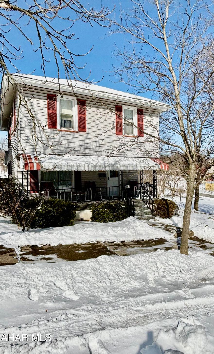 Spacious home is being sold AS IS with 4 city lots. Lots of potential for expansion.  This home offers 4 bedrooms and a large, bright eat in kitchen with walk out access to a 21'X14' covered patio. Outdoor grilling is just steps away from the kitchen! The walk up attic has lots of room for storage or potentially a play area. The one car garage is accessible through the basement. Nice off street parking and tons of yard.