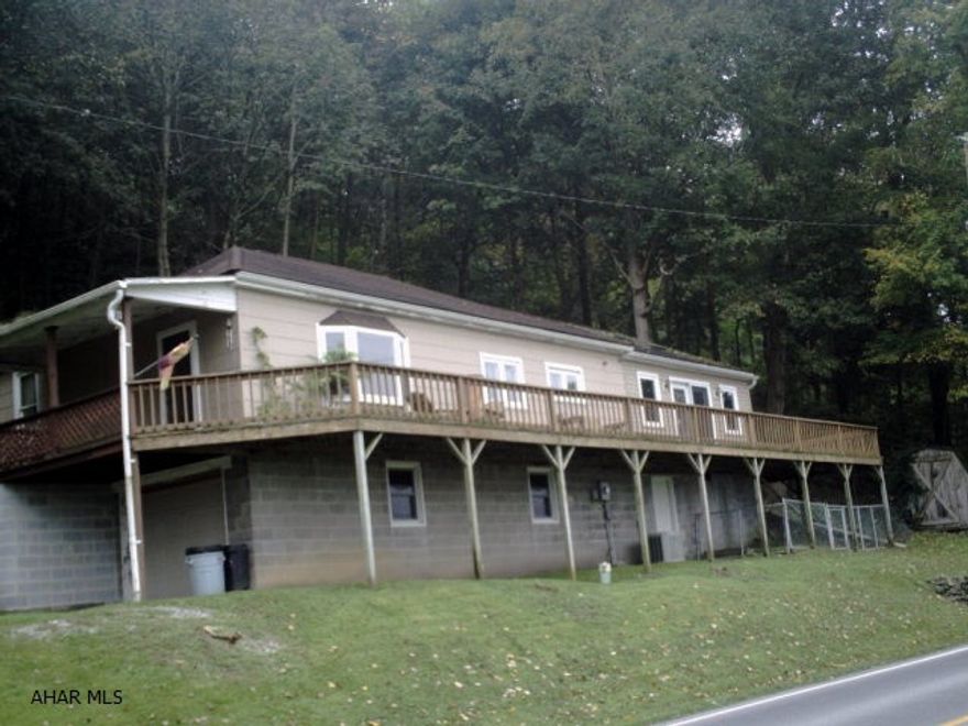 Ranch home with a large extra family rom addition with wrap around deck with a great county view.