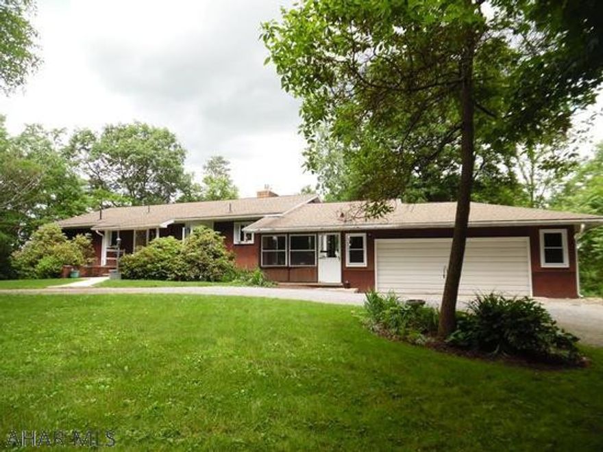 Secluded ranch home on 17.27 wooded acres only minutes to 7 Points Marina, Raystown Lake.  2BR, 2BA home features large eat in kitchen with center island, all appliances and pantry.  Separate dining room and living room with gas fireplace.  Sun room leads to private patio.  Lower level family room with propane stove, laundry area and full bath with area that could be additional bedroom.  2 car garage and 1 integral garage that is extra deep for that long boat or to store your vintage car.  Lots of storage.