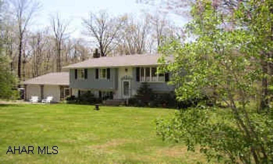 RAISED RANCH, 3RD HOME ON RIGHT. BEAUTIFUL AREA, LARGE FAMILY ROOM WITH WOODBURNER, OFFICE, WORKSHOP, 3/4 BATH.  LOWER LEVEL OPEN LIVING ROOM AND DINING AREA, DECK.  A MUST SEE!  $1500 CARPET ALLOWANCE.
