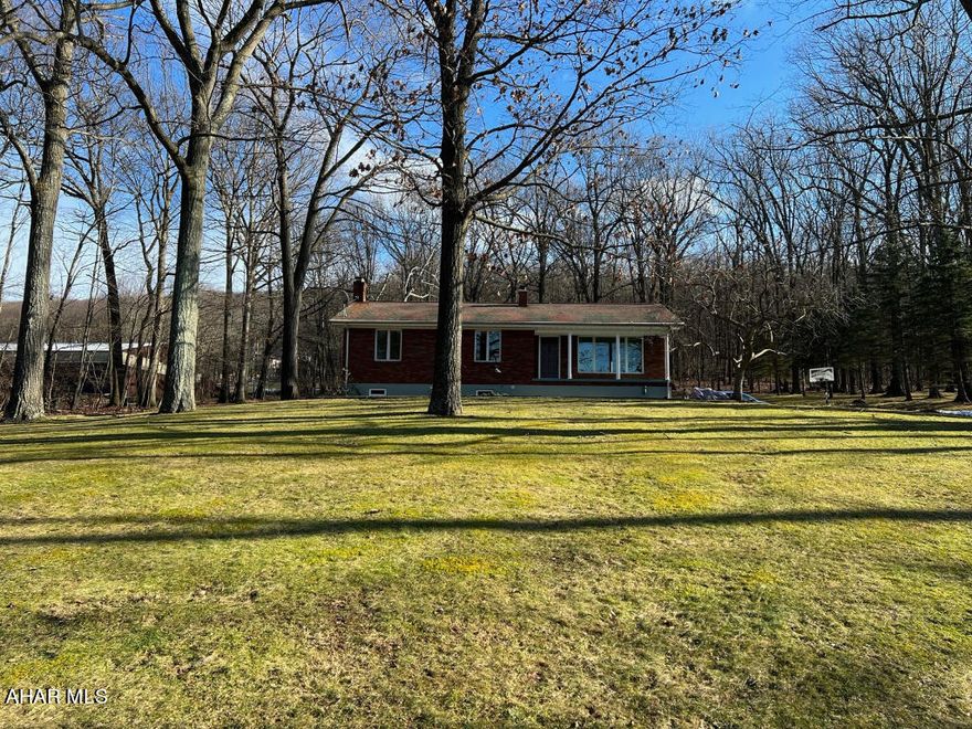 A well-built brick ranch conveniently located just 5 minutes off the boulevard and up Kettle Rd toward Sinking Valley. Lots of wildlife around this 1-acre property backed up against the woods. Living room with a nice view, large kitchen with dining area, 3 bedrooms, and bath on the main floor. Finished basement features a large family room with wood stove, laundry room, spare room, bath, and a small workshop area. There is a set of pull-down stairs to attic storage with 300 sq ft of flooring. You'll spend lots of time enjoying nature on the 15' x 20' patio. A nice 16' x 20' block shed sits at the top of the property. This well maintained house is being sold as-is.  Great house, lots of nature, just out of town....just for you.