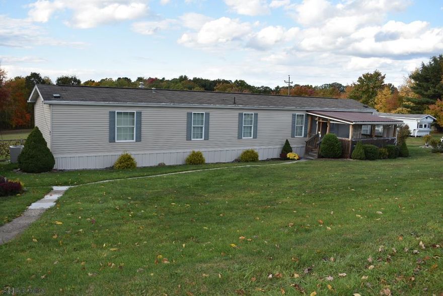 This well cared for 3 br 2 bath mobile home sits on a nicely landscaped 3 acre lot with fruit trees and grapevines.  This home offers an oversized 2 car detached garage with woodburner, a covered front porch, back deck and a shed.  There is an extra trailer that was used as a workshop but could be used for storage.