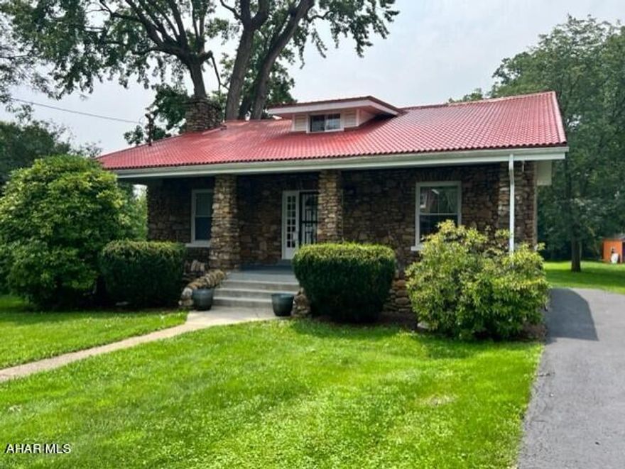This charming 1920 stone house in Altoona,  boasts three bedrooms with the possibility of a fourth bedroom, one full and one half bath, and beautiful hardwood floors. Enjoy the cozy fireplace in the living room on chilly evenings or spend time on the large front porch, soaking up the sun and enjoying the fresh air. Comes with appliances, including stove, refrigerator, washer, and dryer, and heat and hot water is provided by natural gas. In addition, the spacious, gorgeous backyard with a stream flowing at the back of the property is perfect for outdoor living and entertaining, with a patio providing additional relaxation space. Basement has office space as well as a 3/4 bath.  Don't miss out on this gem of a property!
