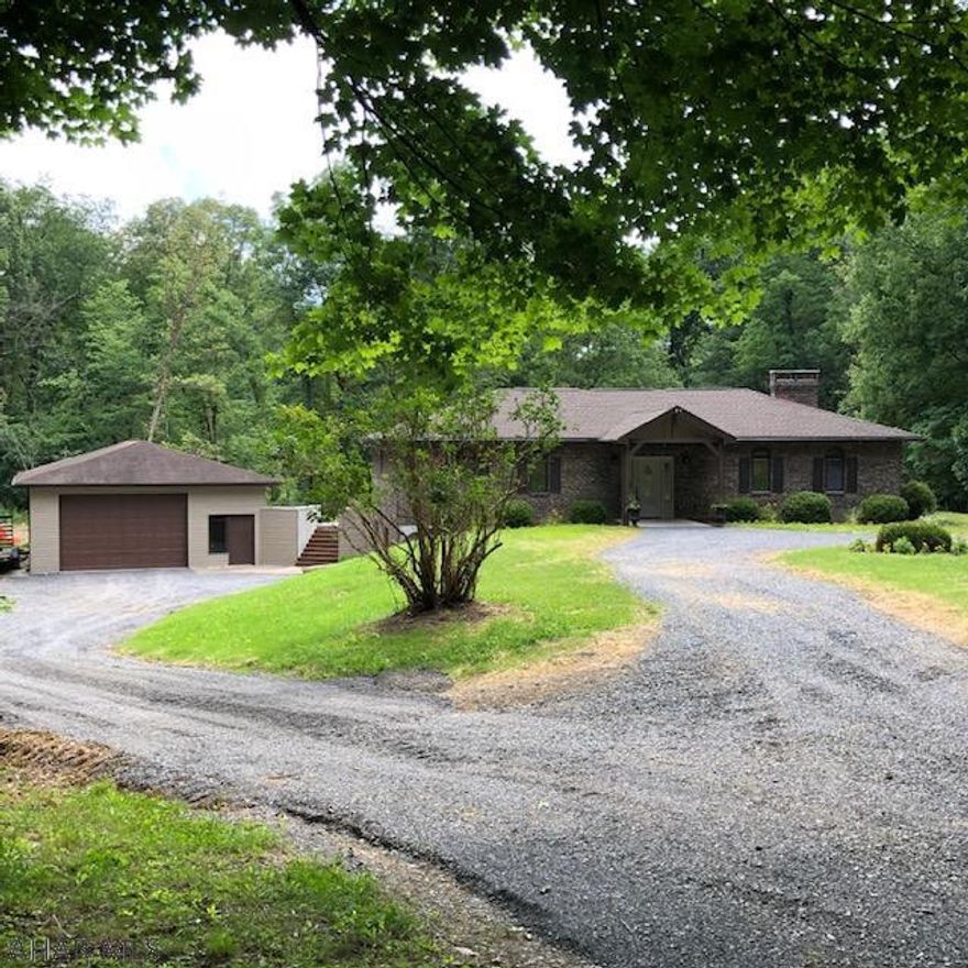 You'll be delighted by what this newly remodeled home has to offer on a secluded and mostly wooded 4 acre lot.  Upon entering the spacious foyer you'll see the open concept kitchen and dining area that leads to a large covered patio for easy outdoor entertaining.  Take a few steps down in to the unique sunken living room with its round top windows and expansive brick fireplace.  Enjoy the master suite with a gorgeous tiled en-suite 3/4 bath, double closets and patio space all its own. This home has 2 two additional bedrooms and a full bath with hidden laundry area conveniently located on the main floor.  Add in the circular driveway and oversized garage that will fit all of the outdoor toys you've always wanted and this could be your perfect home. Schedule your tour now!