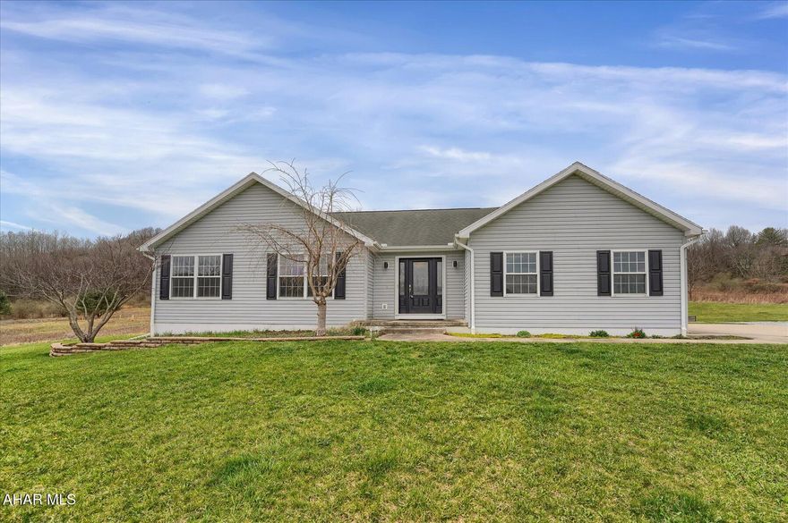 Welcome to this lovely modern ranch home, nestled on a peaceful 2.15-acre property in the serene rural setting of Warriors Mark. Enjoy stunning views and privacy as the property backs up to lush woods at the end of quiet Champaign Lane. While this home offers the tranquility of rural living, it's still conveniently close to town for all your daily needs.
This well-maintained home features a spacious layout, including a large 2-car garage and a beautifully level yard with raised garden beds, a cozy fire pit, and a charming chicken coop—perfect for those looking to embrace outdoor living. The expansive full basement offers high ceilings and is ready for finishing, providing endless possibilities for additional living space.
The heart of the home is the large kitchen and dining area, featuring a two-tier island, stainless steel appliances, and a pantry—ideal for cooking and entertaining. The bright and airy living room boasts a soaring cathedral ceiling, a propane fireplace, and access to a large rear deck, complete with a gazebo cover for outdoor relaxation and gatherings.
Bonus Opportunity: The adjoining 4.47-acre lot is also available for sale, offering the potential to expand your outdoor space for even more privacy and recreation.
Don't miss the chance to make this stunning property your home, where peaceful rural living meets modern comfort and convenience.