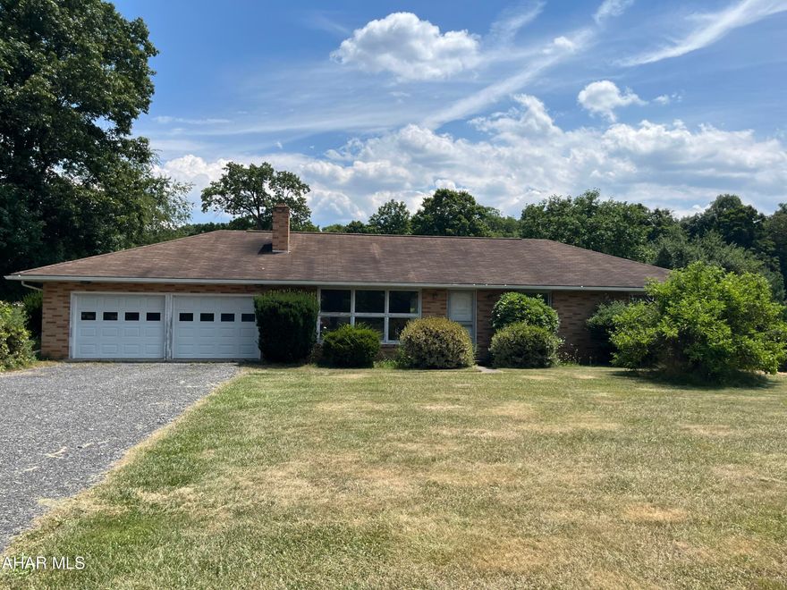 Fantastic brick ranch house on 1.77 acres.  So much potential with the wide open outdoor space. Privacy on this lot is hard to beat! Attached 2 car garage,  living room with brick accent wall with a wood burning fireplace, dining room with patio doors that over look the large back yard. Basement has second full bath, laundry, great storage and beginnings of an additional living room.  Great location close to all amenities, hospital, Rt 30, I-99, I-70, and between Bedford and Everett.