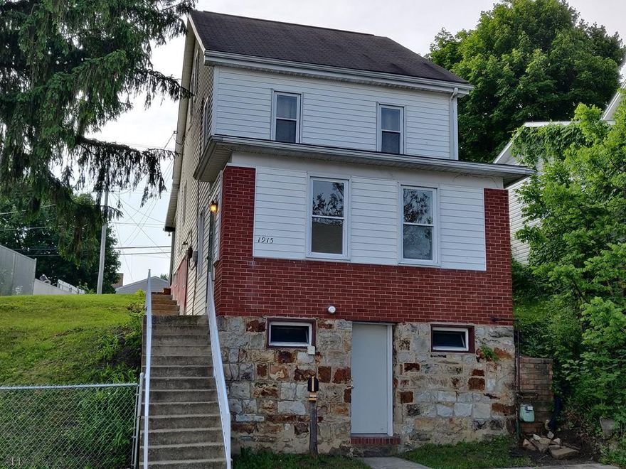 3 BR, 1 Bath Home on Double Lot, New Carpet, First Floor Laundry, Office, Shed, Large Garage with Gas + Heat, Off Street Parking at Alley, Fenced Yard, Covered Porch.