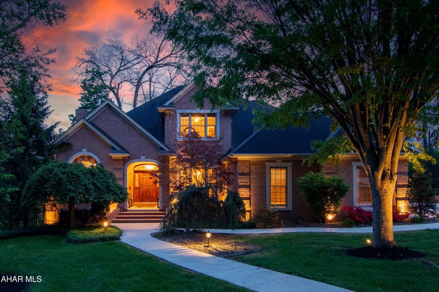 Stunning custom brick traditional home offering timeless architecture, exceptional living space, and impressive indoor-outdoor entertaining areas. Situated on a beautifully landscaped lot, this residence features dramatic curb appeal with  exterior lighting, mature trees, and a welcoming covered entry. Inside, spacious living areas showcase oversized windows, abundant natural light, recessed lighting, and a cozy fireplace creating a warm and inviting atmosphere.
The expansive kitchen offers abundant cabinetry, new countertops, center island seating, and generous prep space ideal for everyday living and entertaining. The 1st floor primary suite provides a relaxing retreat with large windows, custom trim details, and ample space to unwind. Multiple living and gathering spaces throughout the home provide flexibility for entertaining, recreation, or work-from-home needs.
Outdoor amenities include a screened-in porch, covered deck and patio areas, as well as a beautifully maintained yard surrounded by mature landscaping and wooded views. Additional highlights include an attached multi-car garage, quality brick construction, and thoughtfully designed outdoor living spaces that extend the home's functionality year-round.
This exceptional property combines classic traditional styling with spacious modern living in a picturesque setting. Call today schedule a private tour.