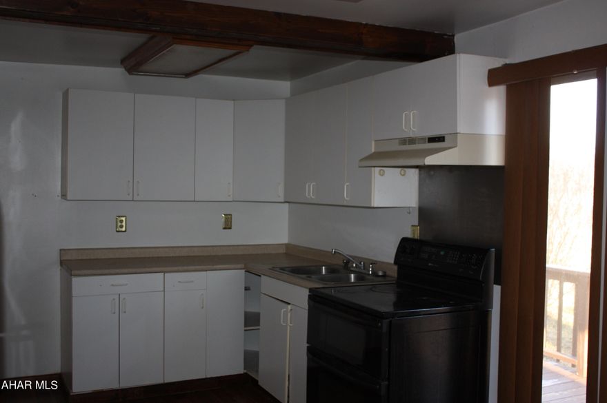 Starter Home or Business.  This Property is Residential and/or Commercial.  Large parking lot for commercial use, Home has 3 BR, 1 and 1&3/4 Bathrooms, LR, DR, Extra room for pantry use or utility use.  Sliding glass door to deck, front covered porch and a large yard. Seller is a Licensed  Realtor and is motivated to sell.