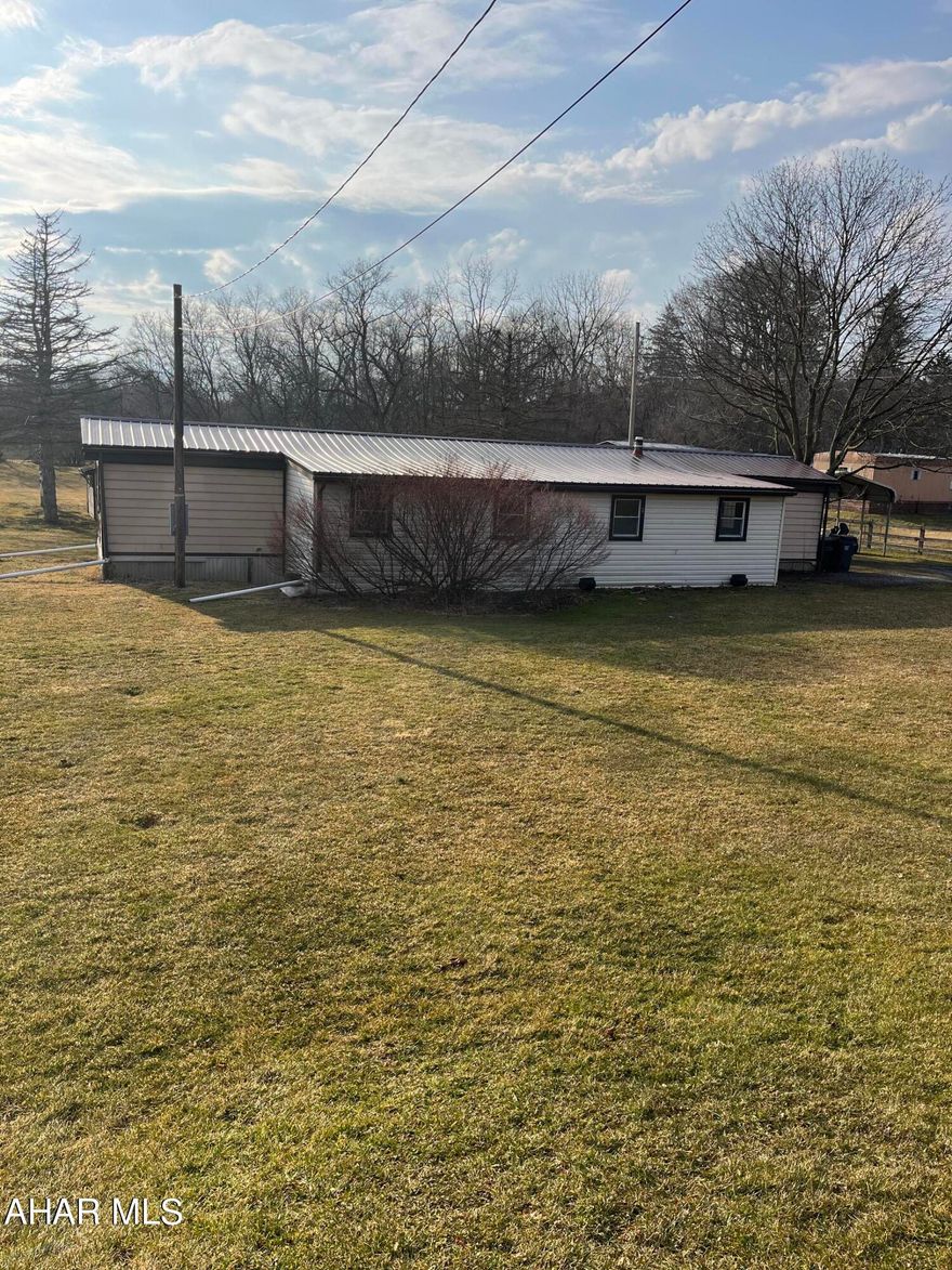 This property would make the perfect building site with small babbling brook and access to both Centre and Blair Co. 1980 single wide trailer. Public water/septic. New metal roof (5 yrs) enclosed porch for extra space. Trailer definitely needs work being sold ''as is'' estate will make no repairs. Could be a good weekend retreat or hunting camp as well. Plenty of wildlife!!