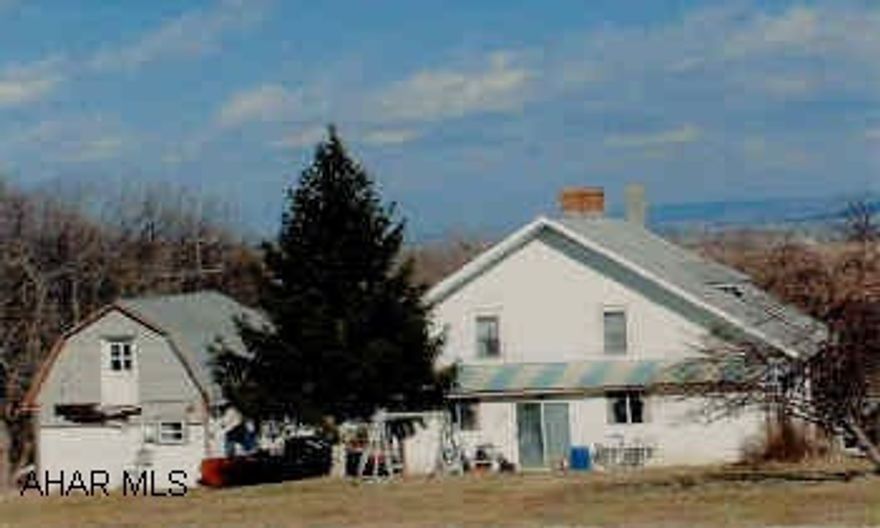 Cape Cod 4BR, 1 full bath, 2-3/4 baths, LR, DR, FRm Kitchen eat-in and laundry, foyer, full basement, walk-out, 2.33 ac hillside setting with mountain views. Out Buildings, 2-car garage, barn/workshop, 2-bedroom Guest house. Spring water and well water. Newer oil furnace, tank. ALSO fruit trees.