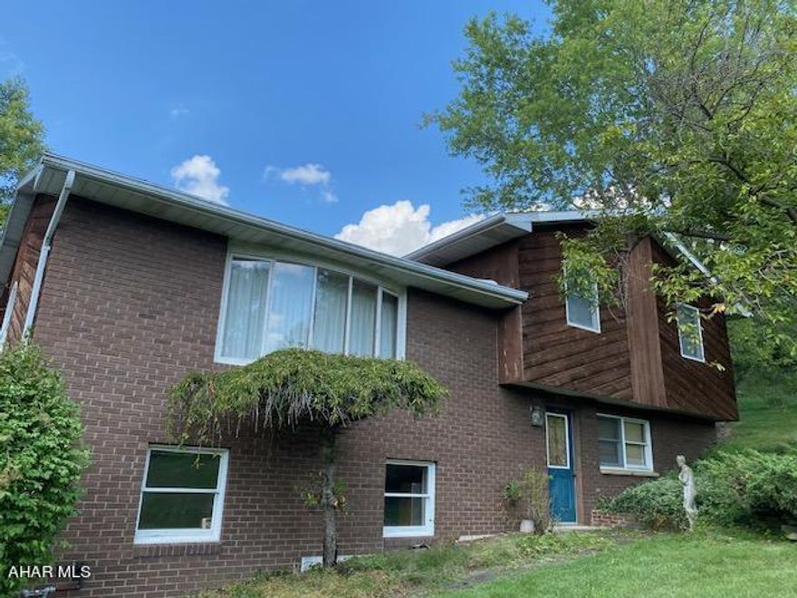 GREAT OPPORTUNITY- HOLLIDAYSBURG SCHOOL! SELLER ASSIST/UPDATE ALLOWANCE. 1 YEAR HOME WARRANTY! Listed below market value and ready for your touch! Home is well laid out and very functional, but kitchen and baths and some decor are original. 
We've done the important updates: New architectural roof less than 2 years old.  Newer top of the line gas furnace, central air conditioner, upgraded appliances and custom maple mantel with newer gas log fireplace.  Mantel has 55'+ diagonal space for TV.  Large deck with gazebo has great view of mountains and sunset. Over half acre terraced corner lot with an out back area great for sledding, or learning to ski! 2 car int garage. All levels sunlight.  8'x14' shed with covered porch, windows and screens great for She Shack, Playhouse, Potting Shed, Shop or Storage. Wired inside and ready for electric service. 
Seller assistance or allowance for updates Home Warranty available. Will provide comps showing market value in this area $280,000 to $300,000+.  Great for flip or wonderful home.  Agent original owner. Being Sold AS IS. Seller may help with down payment or closing costs as per lender guidelines.