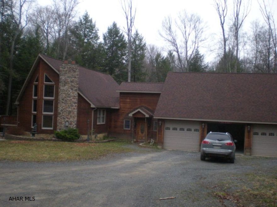 1 1/2 story cedar sided home with 3-BR, 2-BA. Large 3 car garage with family room above. 1 acre.