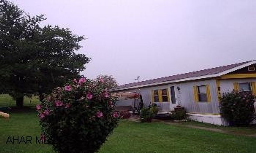 Very Well maintained moble home on a double lot.New shed included. Lovely lot