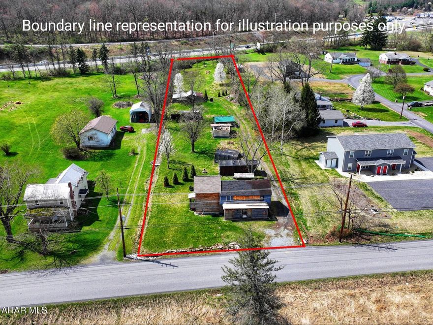 1.25+/- Acres with public water and sewer on site. The property offers a great location for multi-family housing, commercial space, storage units, truck/trailer drop yard, or a single-family home with no zoning. There are multiple structures on site and the large structure has hand hewn logs in a portion of it. The seller will make no repairs.